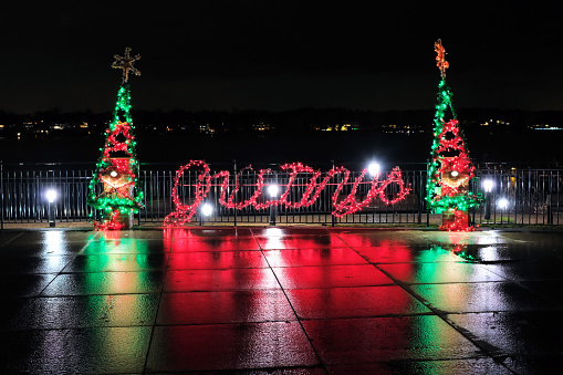 Frisco, Texas, USA - December 17th, 2021:  Downtown street, Christmas tree and City Hall beautifully illuminated for Christmas