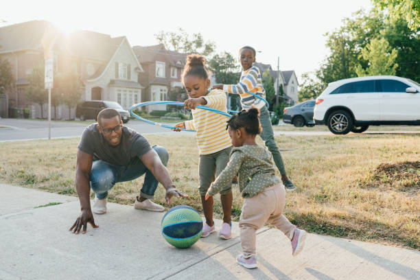istock Dad with kids playing outdoors 1454050825