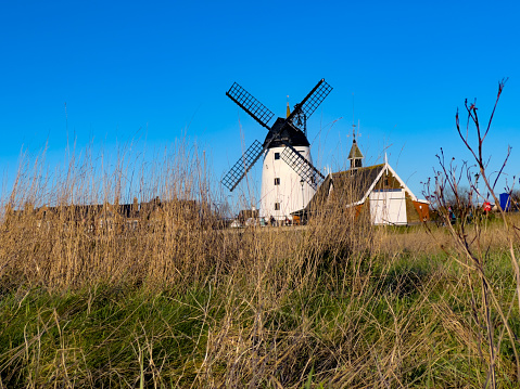 Photograph of Lytham Windmill and Marshland taken on a cold winters day with cloudless blue skies. Photograph taken in Lytham, St Annes near Blackpool, Lancashire