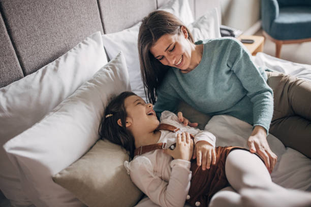 istock Mother and daughter in hotel room 1454052818