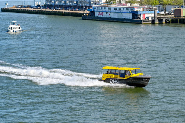 fast water taxi on the Nieuwe Maas river in Rotterdam Rotterdam, Netherlands - August 2022: Small fast water taxi on the Nieuwe Maas river in Rotterdam. The ferry service is operated by the DHG company. watertaxi stock pictures, royalty-free photos & images