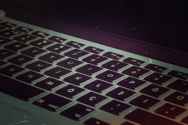 istock Open laptop with screen and keyboard view on the textured noir, vintage  background 1454054180