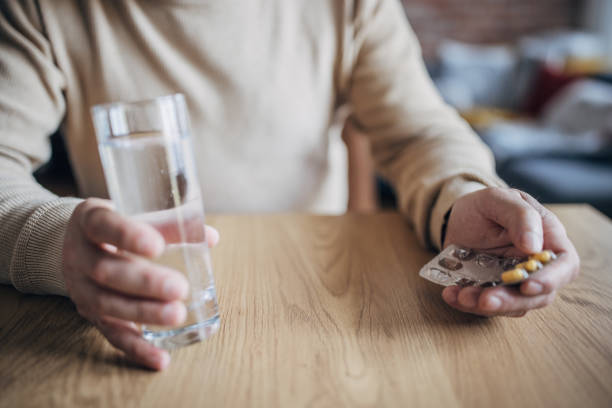 istock Male hands hold a medicine pill 1454054715