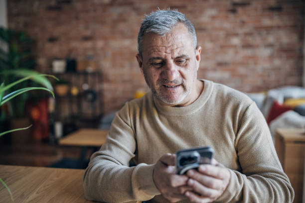 istock Businessman uses smartphone, works from home 1454055589