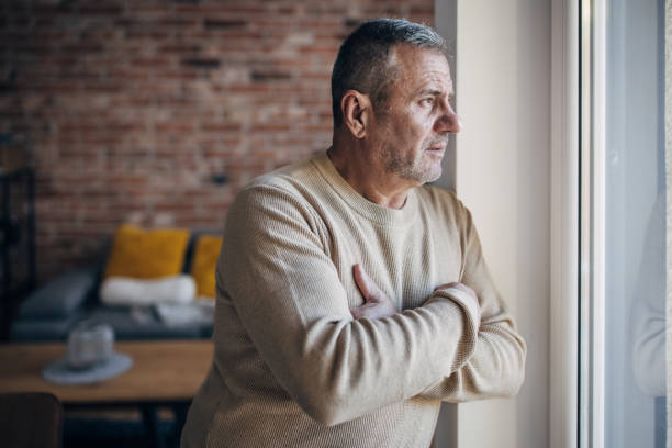 istock A lonely old man looks out the window 1454055691