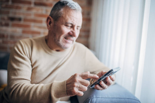 istock Smartphone in the hands of a man, typing on the screen 1454056087