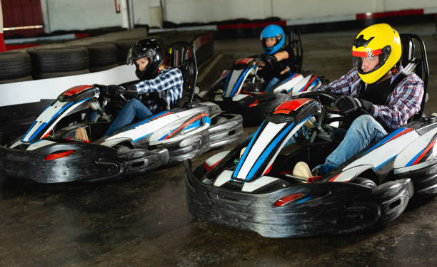 istock People driving go-kart cars 1454060950