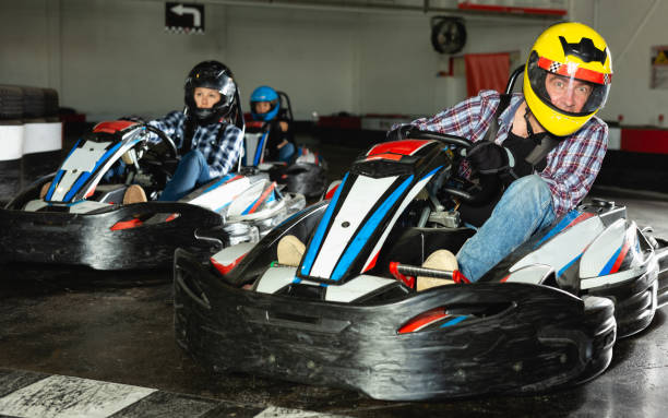 istock People driving go-kart cars 1454060952