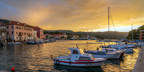 Sunset view of Stari Grad harbour with boats