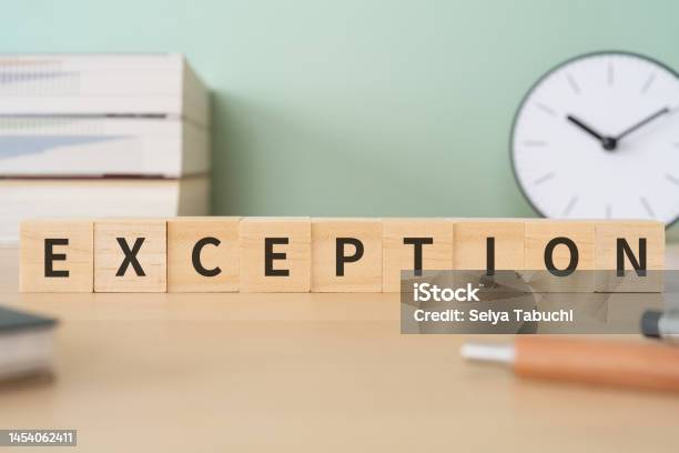 Wooden Blocks With Exception Text Of Concept Pens Notebooks And Books Stock Photo - Download Image Now