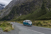 Hippy travel van on road trip at Milford Sound, Fiordland, New Zealand