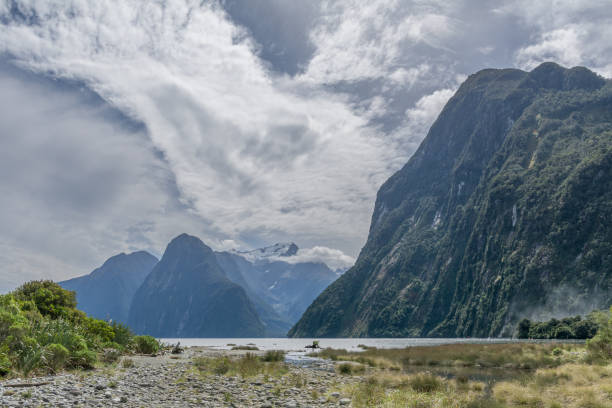istock Scenic nature with water, trees, mountains and clouds 1454065034