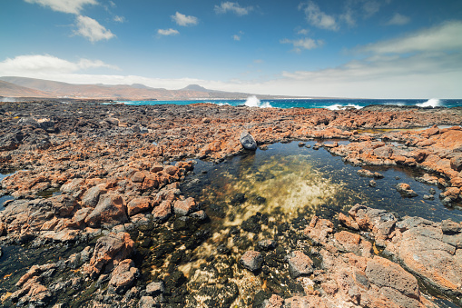 Rock pool and breaking waves on the east coast of Lanzarote
