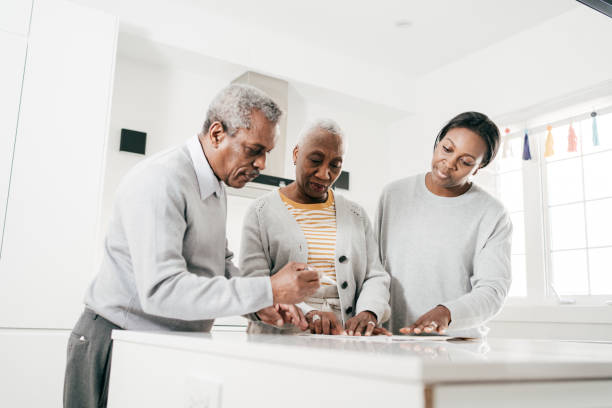 istock Advisor or real estate agent at home with senior couple 1454068046