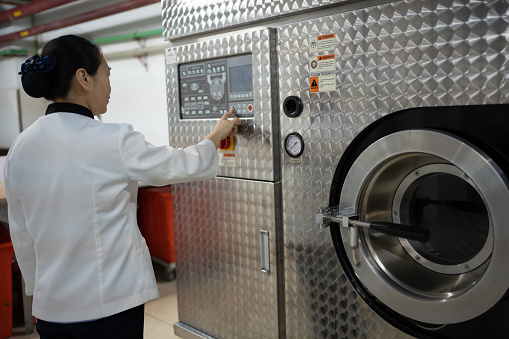 Workers are working on smart dry cleaning machines