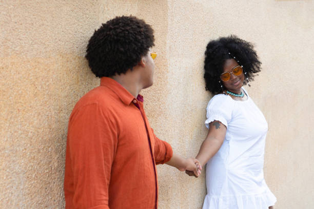 istock Black man with standing next to afro woman both smiling 1454068793