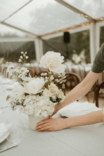 istock Florist arranging white peony flower on a wedding reception table 1454070093