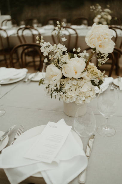 istock Wedding white roses in vase on table decoration 1454070099