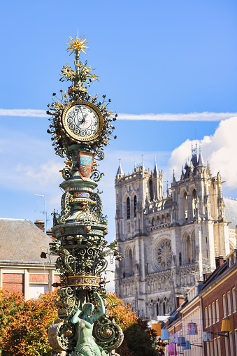 historic street clock with the famous Amiens Cathedral in the background, Amiens, Hauts-de-France, France
