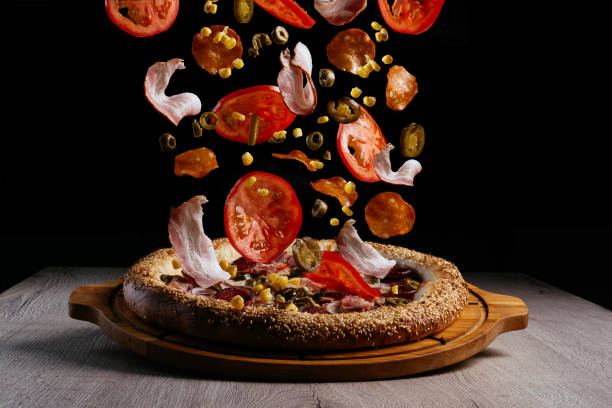 istock levitating pizza ingredients. pizza on a wooden board 1454071150