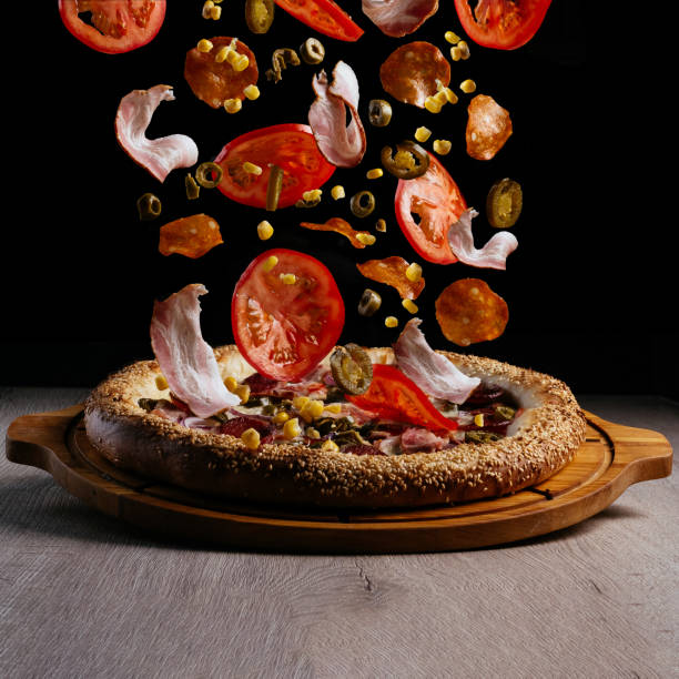 istock levitating pizza ingredients. pizza on a wooden board 1454071164