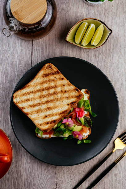 istock sandwich with salmon, cream cheese and herbs on a plate 1454071202