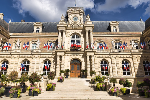 historic old townhall with french national flags at the windows, Amiens, Hauts-de-France, France