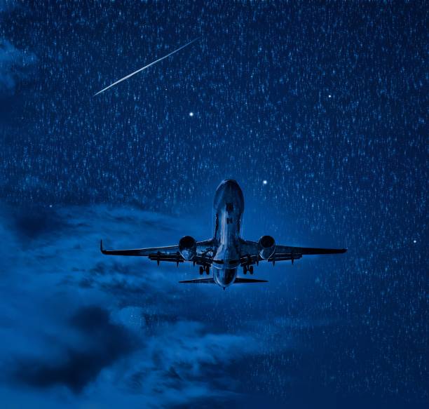 istock plane in air at night with moon shooting star 1454073367