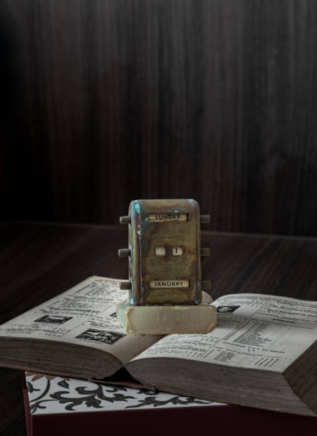 istock Old Antique Brass Desktop Perpetual Calendar Showing January 1th ( Vintage perpetual calendar ) placed on and old book. 1454074596