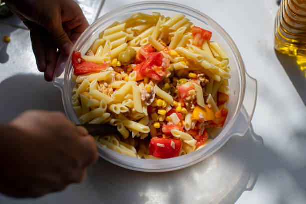 istock Crop person preparing a pasta salad in a bowl 1454074624