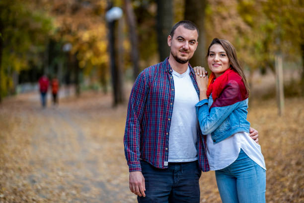 istock Couple walking in the autumn park 1454074629