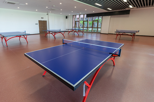 Empty and bright indoor table tennis room