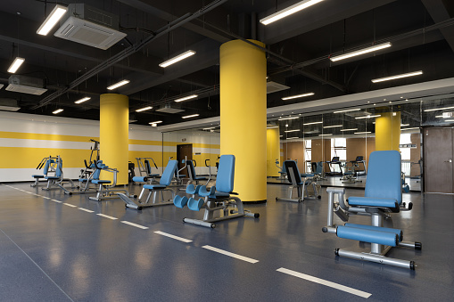 There are many fitness equipment in the empty gym