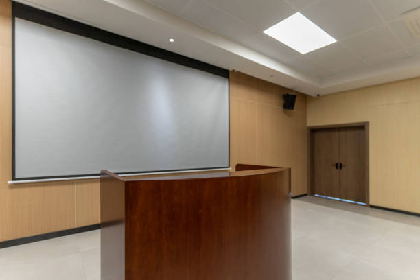 istock Piano and projection screen on the platform of an empty multimedia music training classroom 1454079833