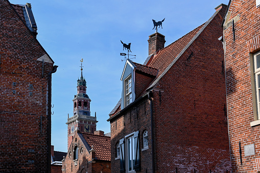 Leer, Ostfriesland, Germany, September 5, 2022 - Historic houses with the town hall tower of Leer (Ostfriesland).