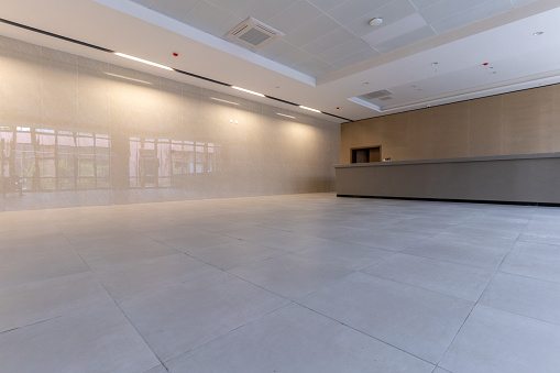 An empty lobby reception area with tiled floors and walls