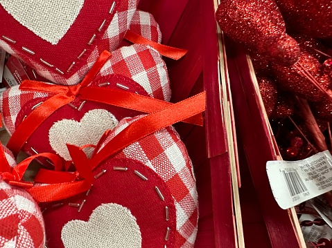 gifts in silver boxes with bows surrounded by red hearts close-up, isolate on a white background