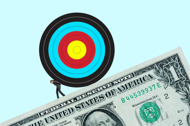 istock Woman Pushing Target Up Slope Created By One Dollar Bill 1454089446