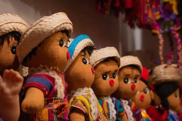 These many dolls were made in South/Central America and are very brightly colored and are wearing small little hats