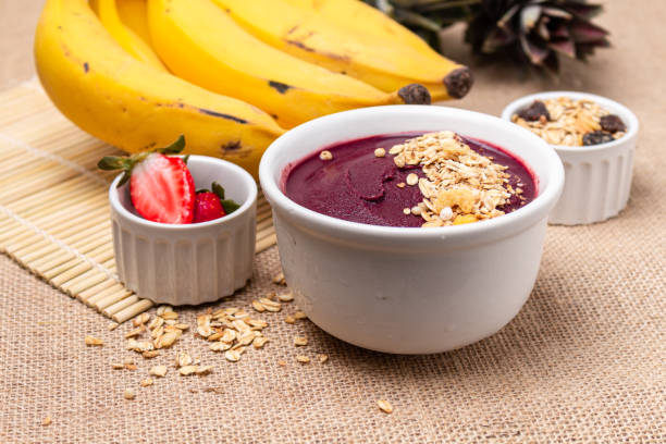 istock Acai bowl on the table with bananas, strawberries and granola. 1454093989