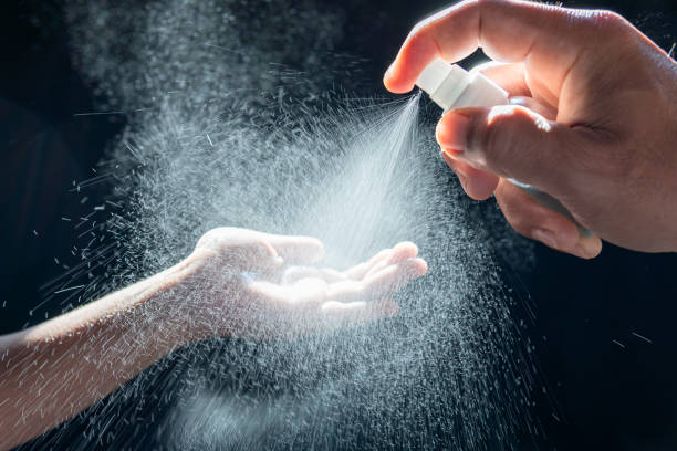istock Motion blur Alcohol spraying disinfection concept,father is spraying alcohol on palms or hands of  daughter people,prevent infection of Covid-19 virus,pandemic of Coronaviru,cleaning,wash hands 1454094612