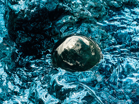 A Crystal ball in the ocean creates a unique background picture.