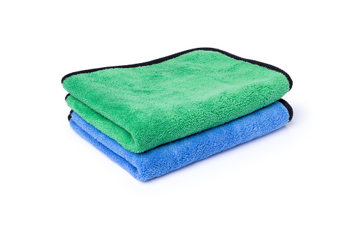 Microfiber cloth in blue and green color isolated on white background with clipping path.