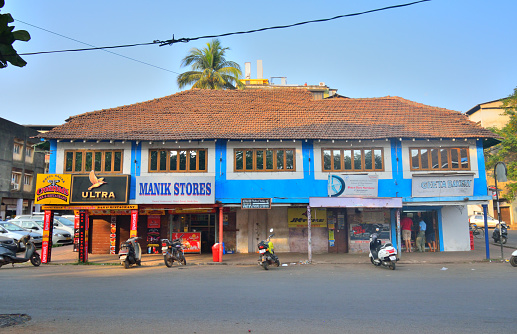 Goa, India - January 24, 2019: An old heritage building housing different shops in the middle of the city.
