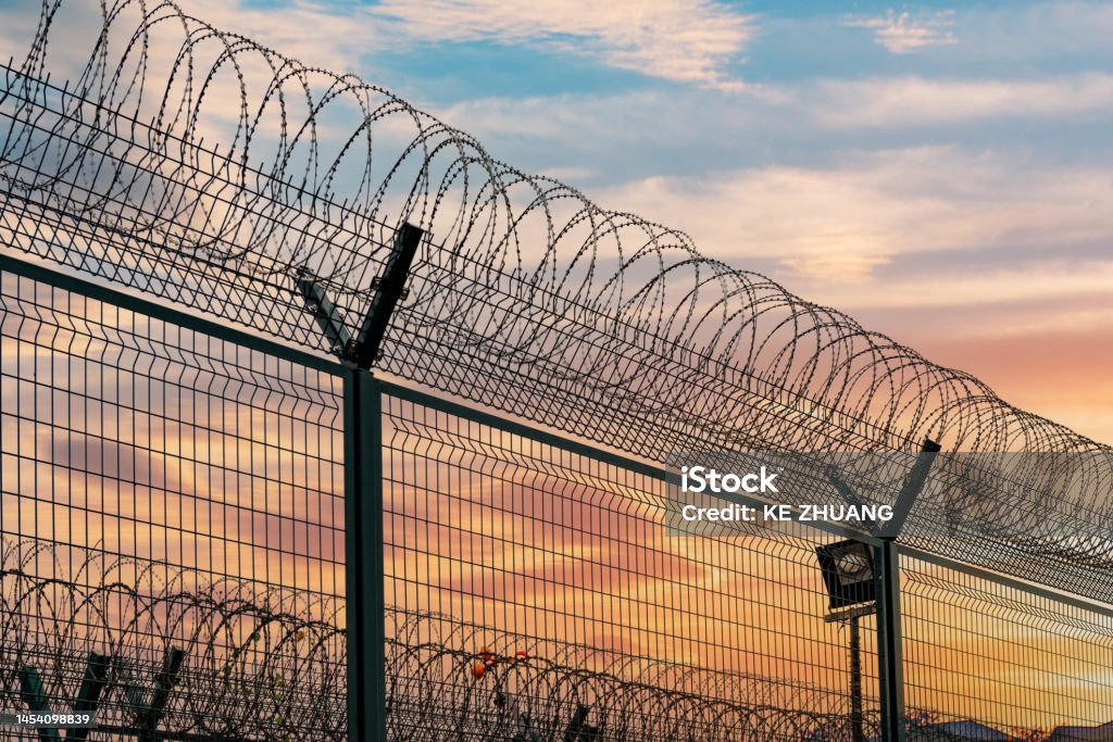 Airport fence, barbed wire fence Prison Stock Photo