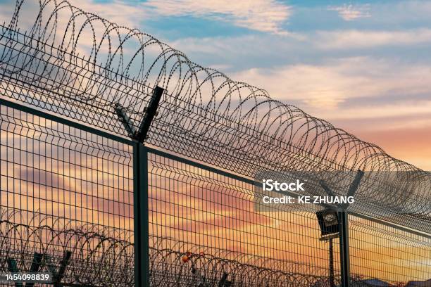 Airport Fence Barbed Wire Fence Stock Photo - Download Image Now - Prison, Airport, Barbed Wire
