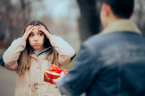 istock Stressed Receiving a Gift Box Forgetting their Anniversary Together 1454101738