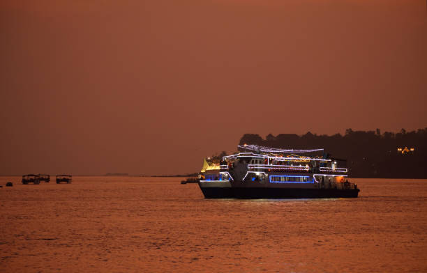 Casino ships sailing in Mandovi river in Goa during sunset.