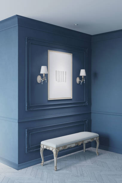 istock A classic dark blue interior with classic white sconces flanking an illuminated vertical poster on a wall with moldings, and a white classic bench on a light parquet floor. 1454102715