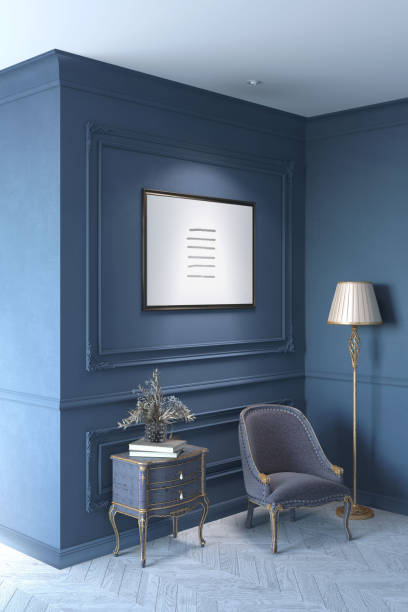 istock A classic dark interior illuminated by a horizontal poster on a dark blue wall with moldings with flowers in a vase on a classic chest of drawers, a golden floor lamp near a cozy armchair. 1454102717